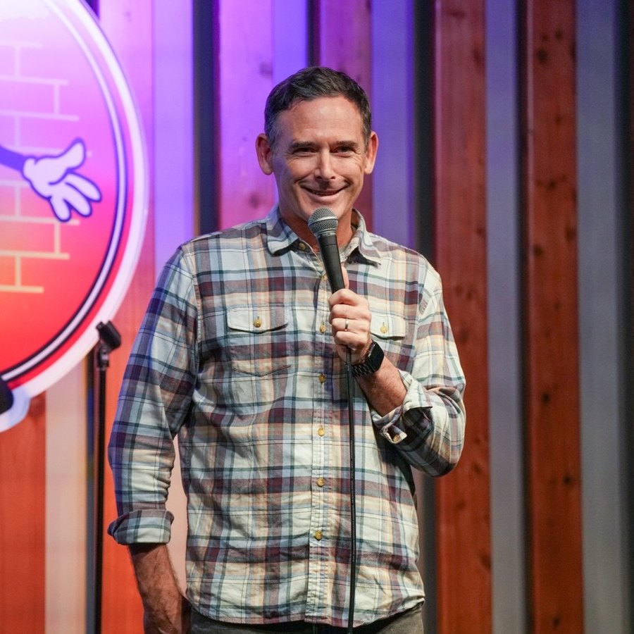 Andy Hendrickson on stage with a microphone