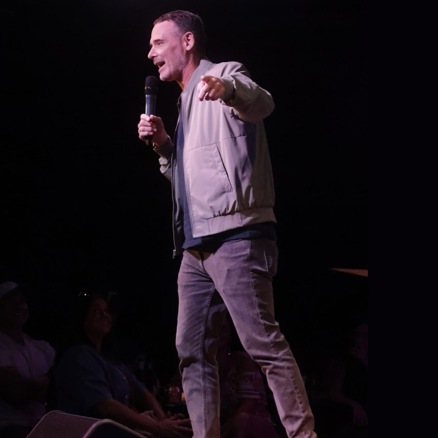 Andy Hendrickson performing under the stage lights